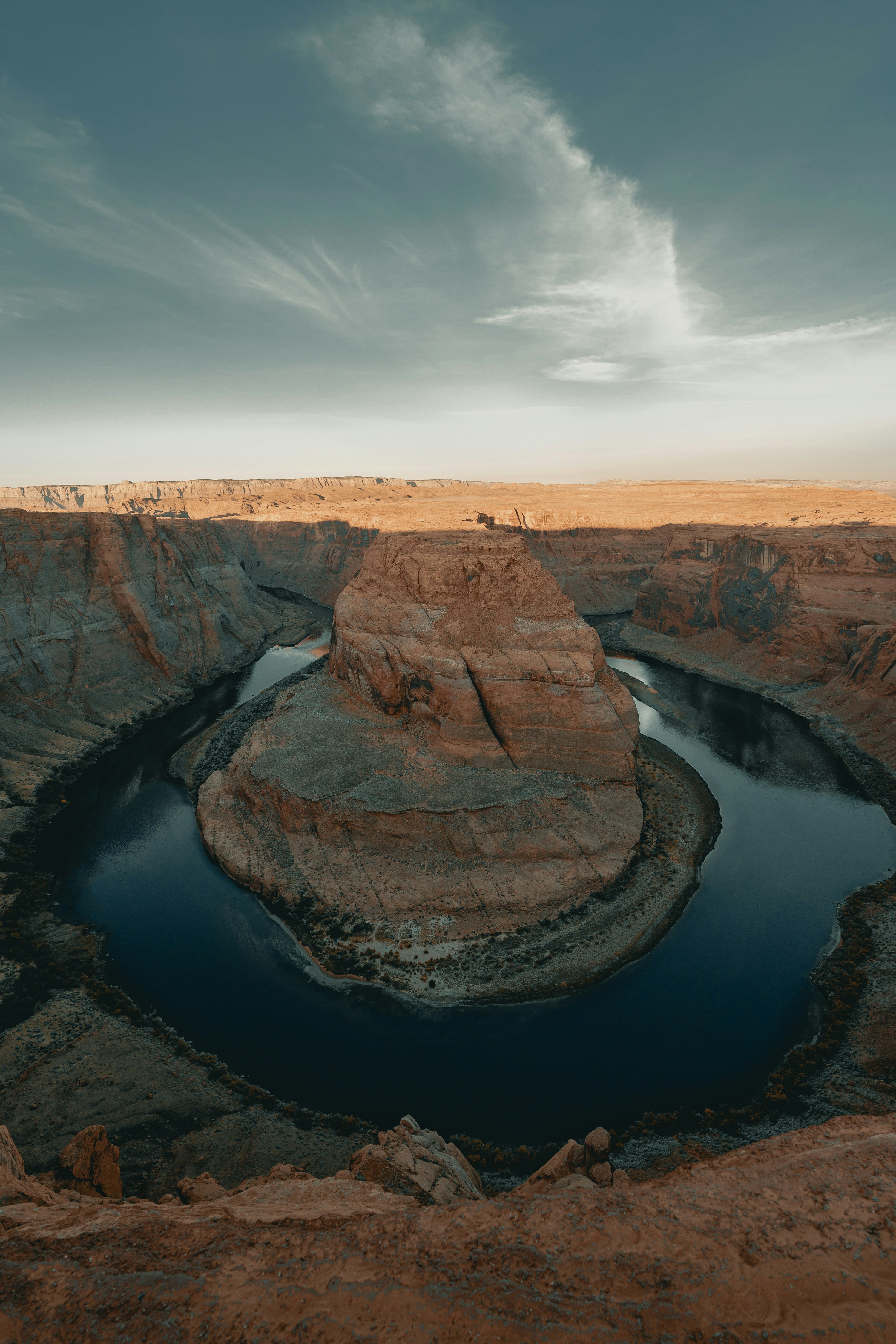 brown rock formation near river during daytime